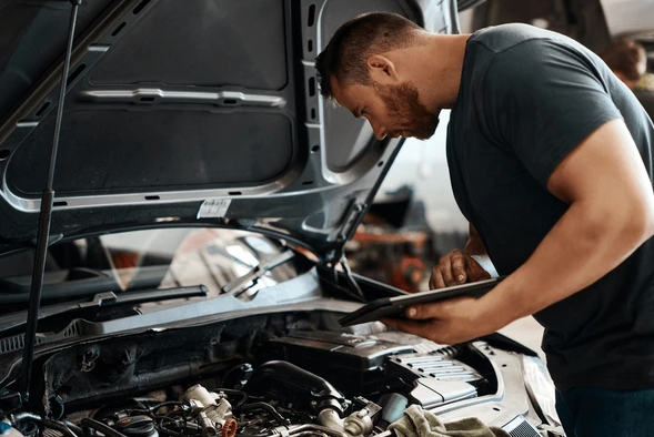 mechanic inspecting vehicle